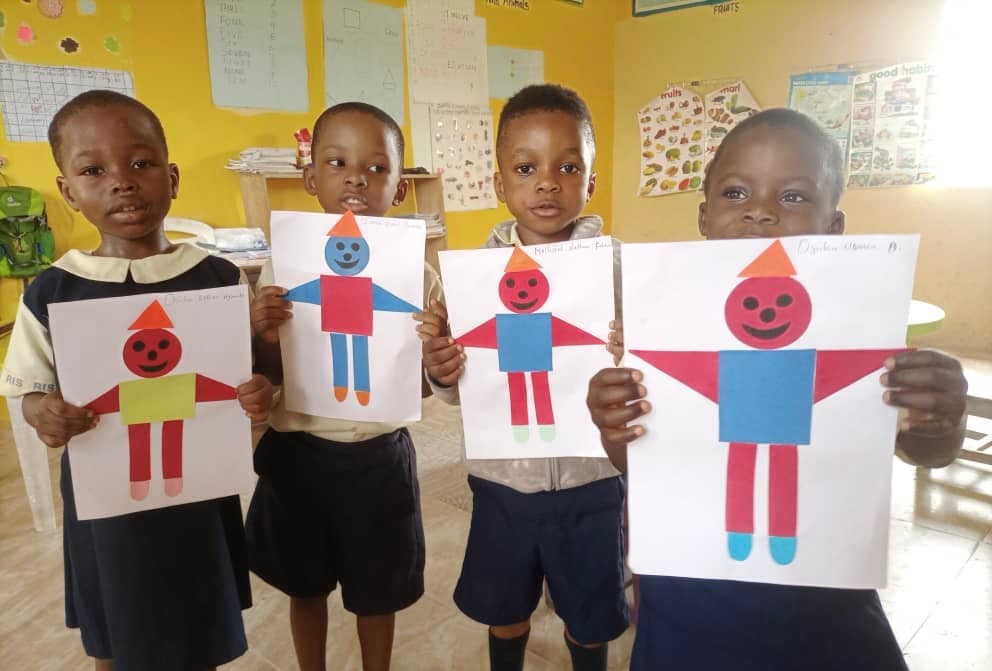 Nursery Children Holding Up Their Artwork